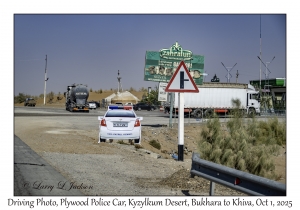 2025-10-01#2838 Driving Photo, Plywood Police Car, Kyzylkum Desert, Bukhara to Khiva, Uzbekistan